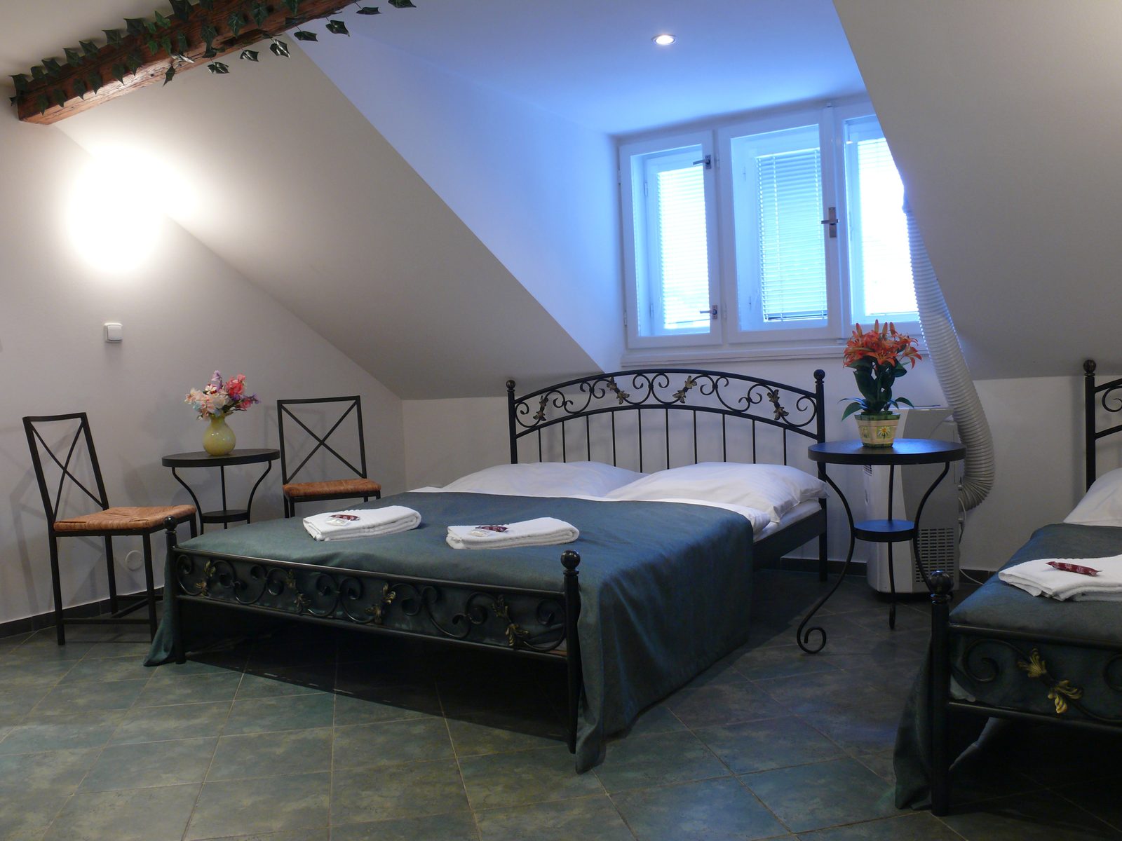 Air-conditioned attic room with sloped ceilings